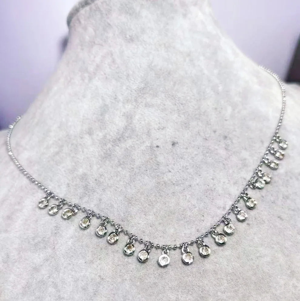 Silver necklace with teardrop-shaped pendants on a mannequin bust.