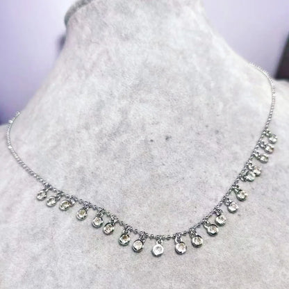 Silver necklace with teardrop-shaped pendants on a mannequin bust.