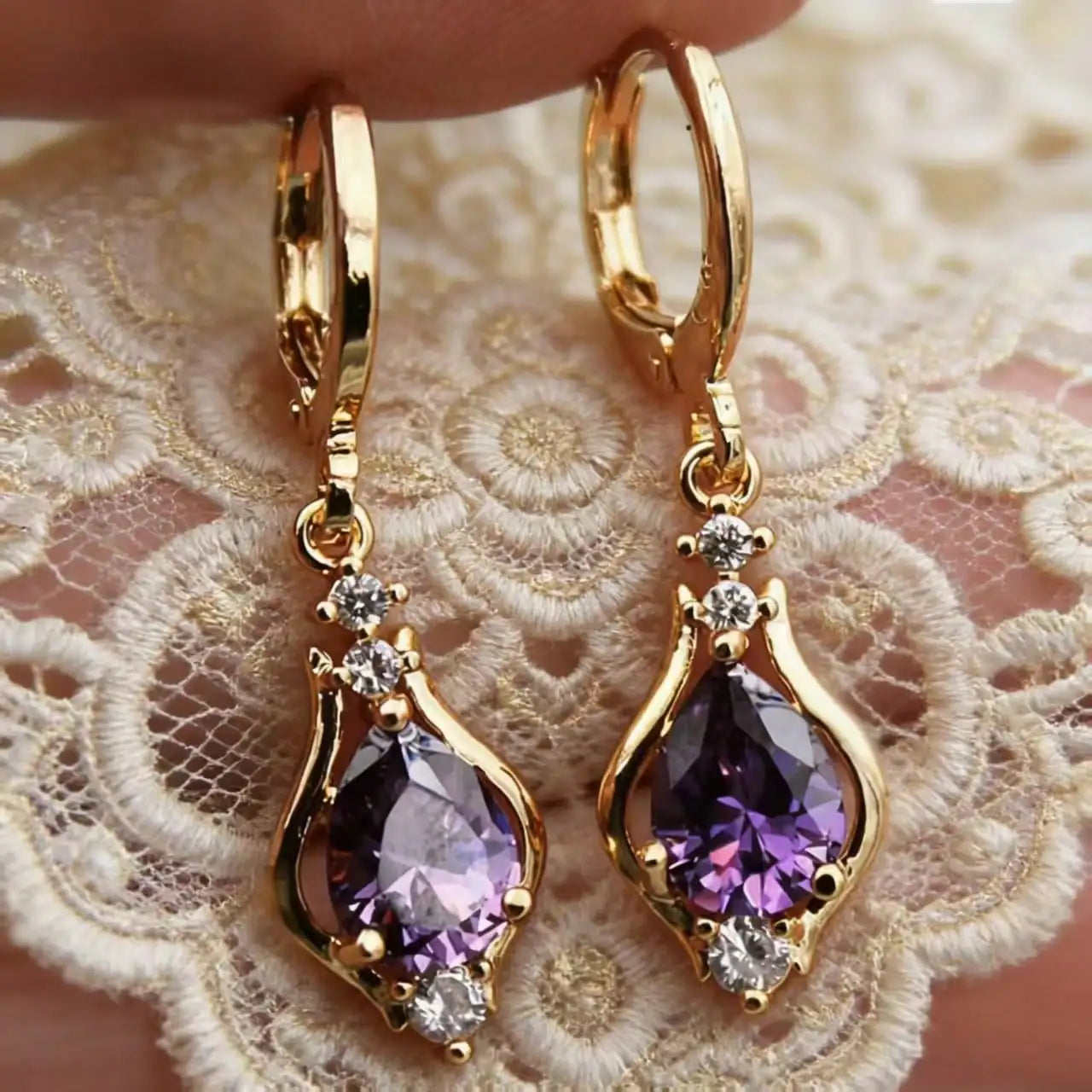 Gold earrings with purple stones 