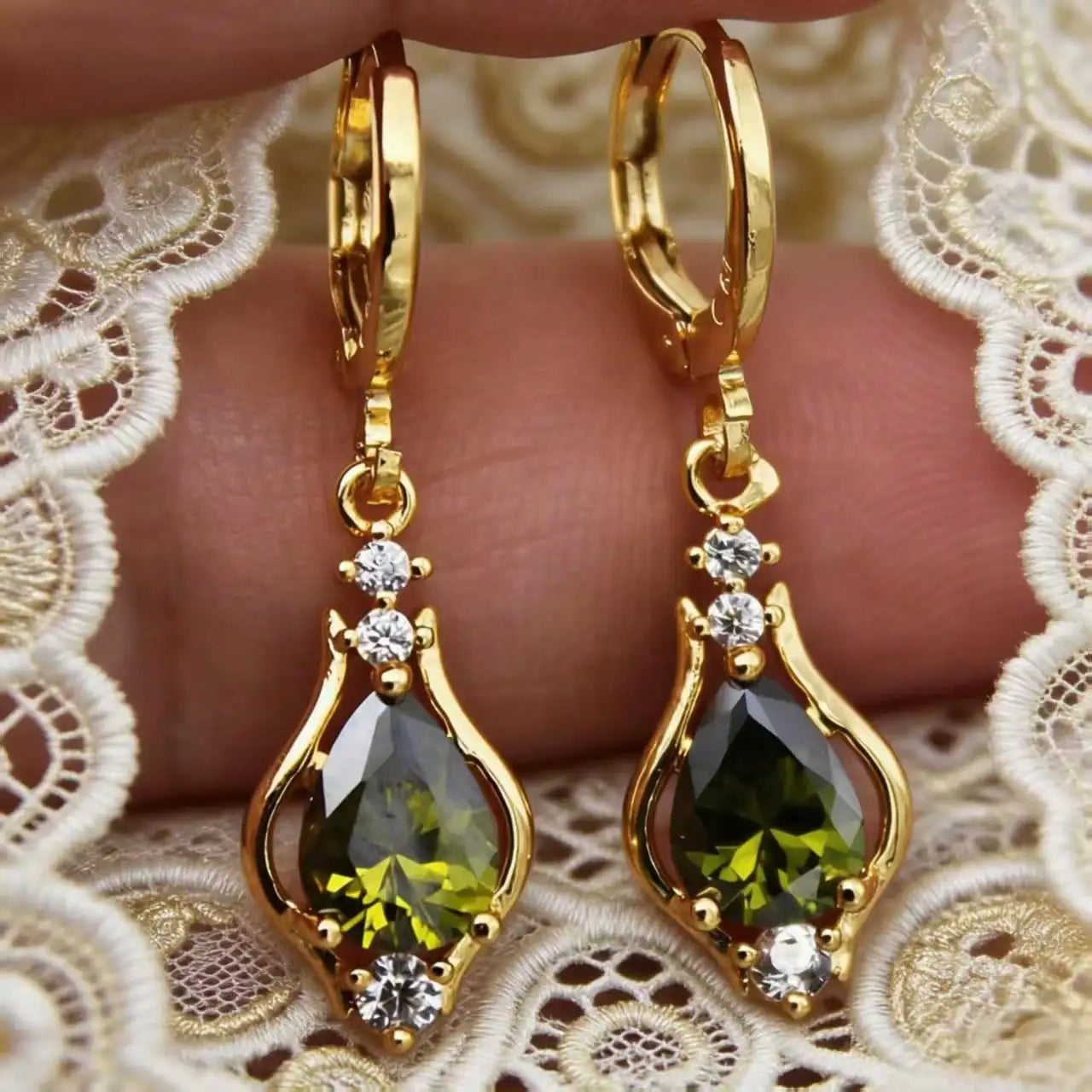 Gold earrings with green gemstones 