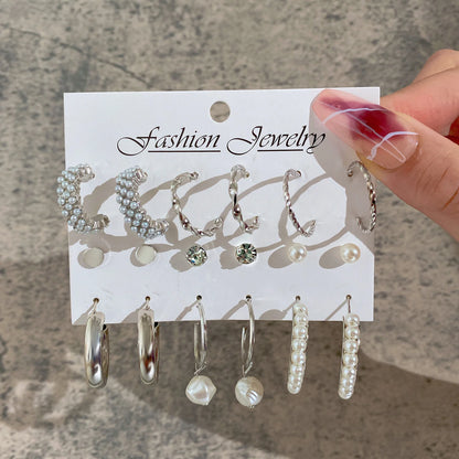 Set of earrings on a 'Fashion Jewelry' card held by a hand.