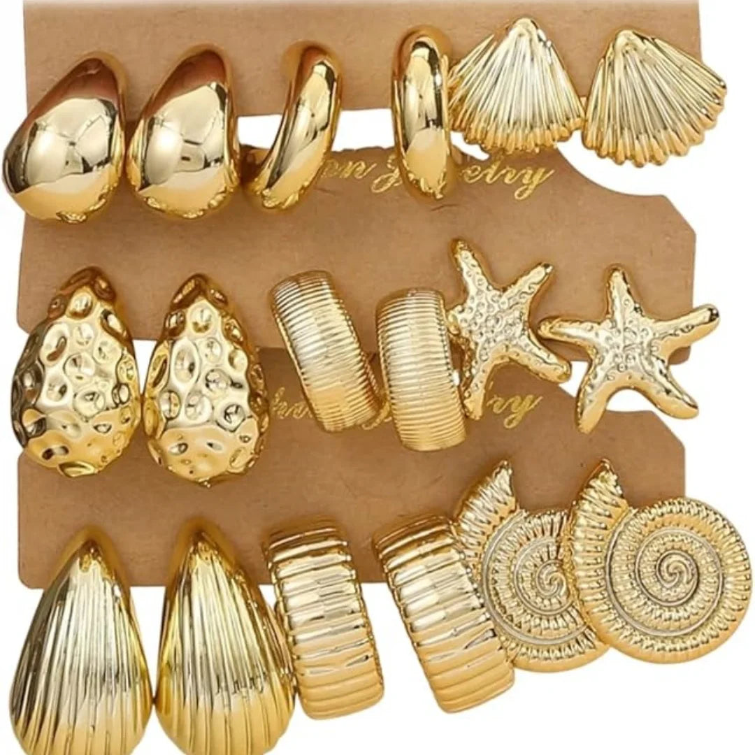 Set of gold earrings on a display card .