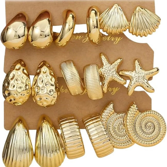 Set of gold earrings on a display card .