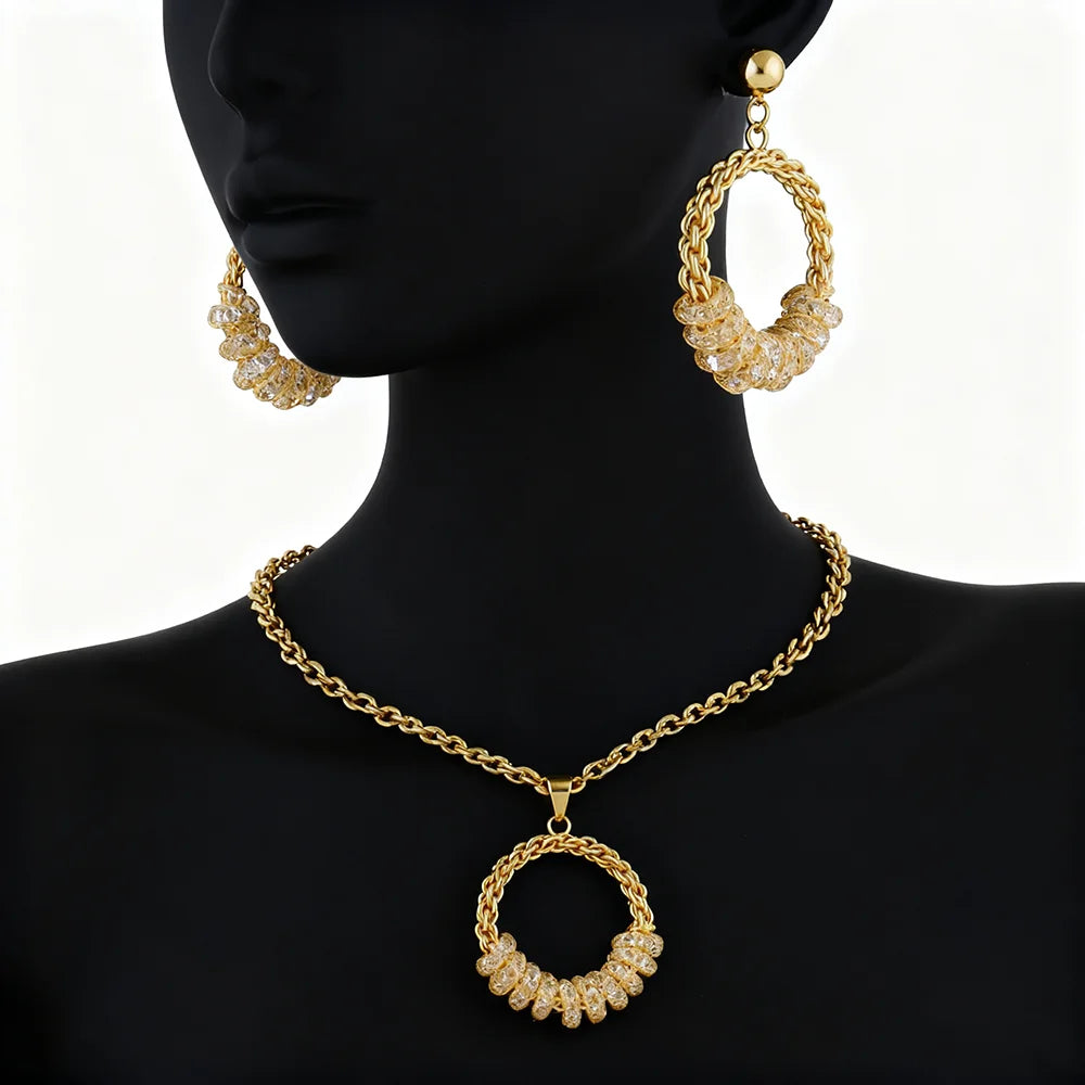 Gold necklace and hoop earrings on a mannequin against a white background