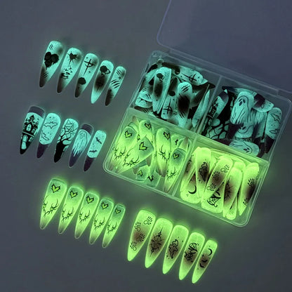 Halloween glow‑in‑the‑dark press‑on nails 96‑piece box packaging with ghost, pumpkin and skull designs.