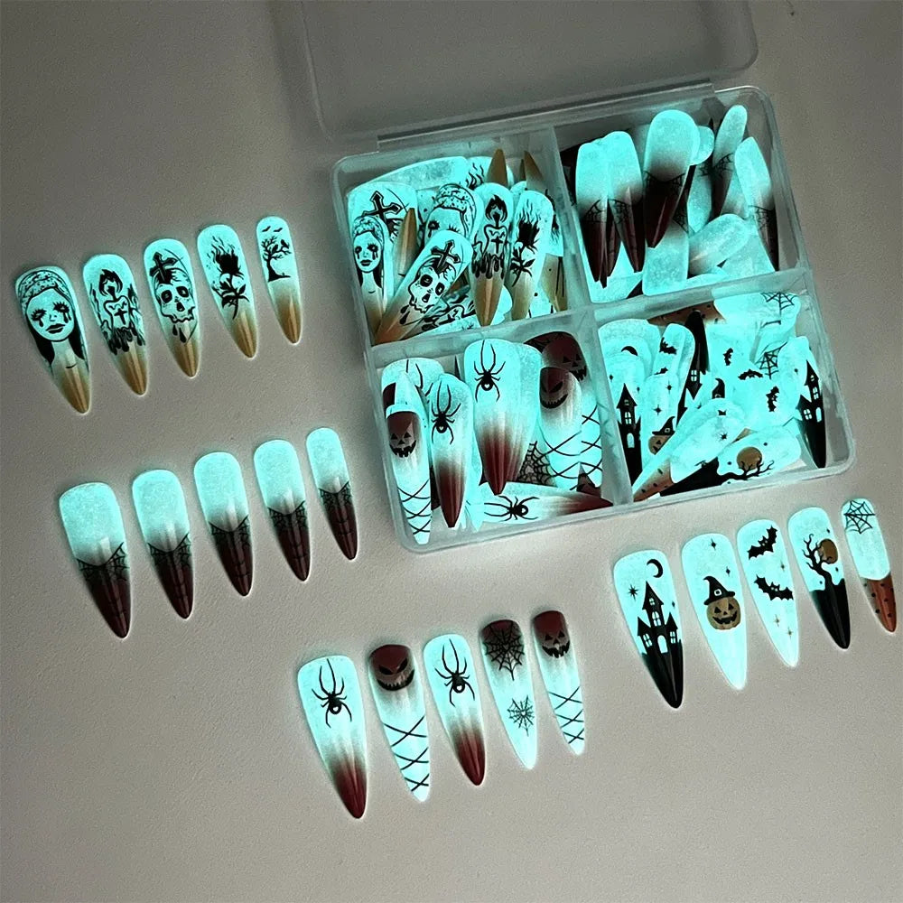 glow‑in‑the‑dark Halloween press‑on nails with skull and cross nail art — long almond shape.