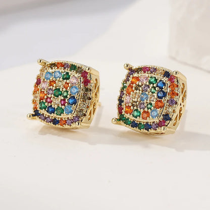 A pair of gold square stud earrings adorned with a colorful array of multicolored rhinestones, displayed on a clean white surface.