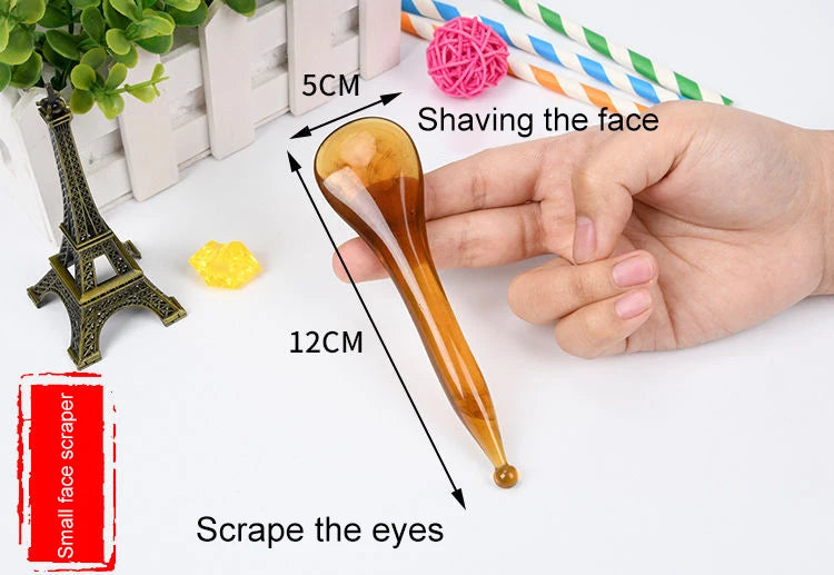 Hand holding a small face scraper with measurements and usage instructions on a white background.