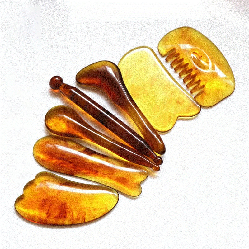 Set of amber-colored hair accessories including clips and a comb on a white background