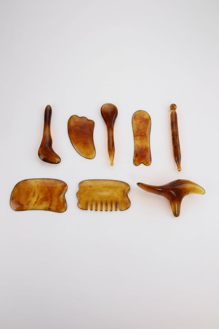 Beeswax scrape therapy set with various tools on a white background