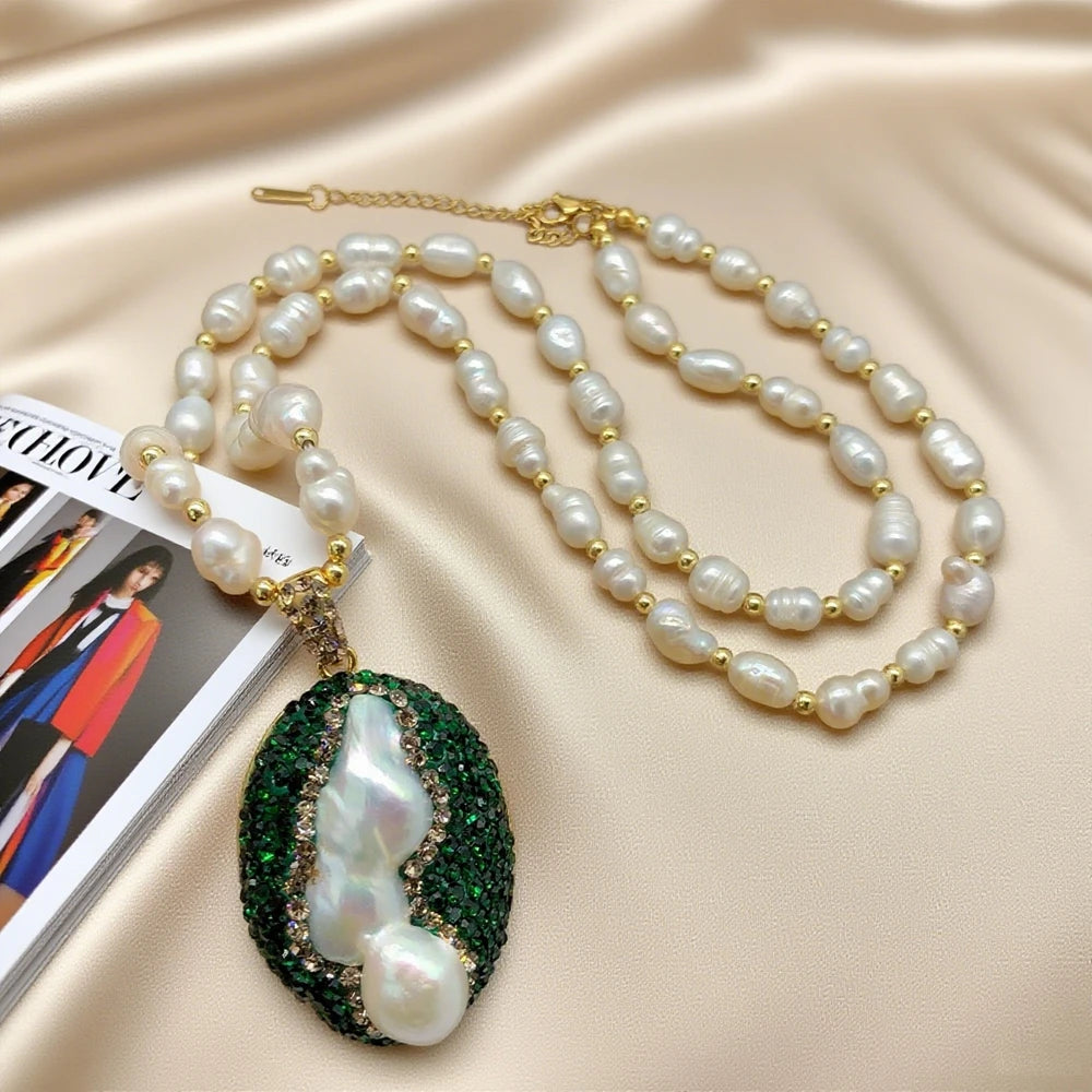 Pearl necklace with a green pendant on a beige fabric background