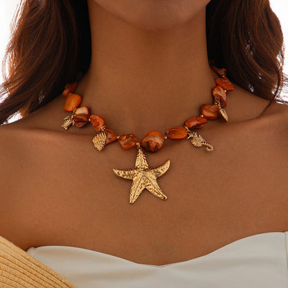 Necklace with starfish pendant and shell beads on a person against a neutral background