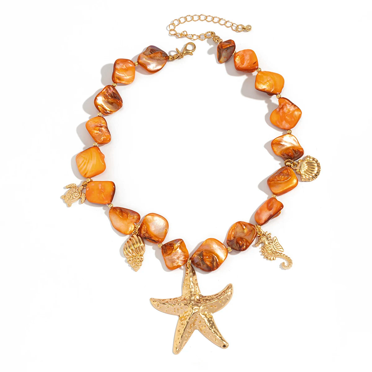Necklace with orange beads and gold starfish pendant on a white background