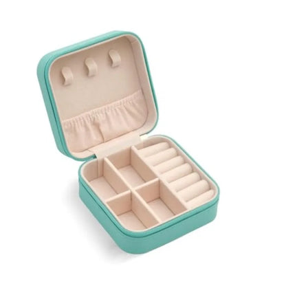 Open turquoise jewelry box with compartments on a white background