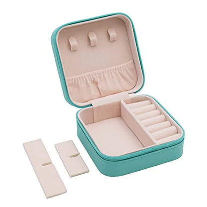 Turquoise jewelry box with beige interior on a white background