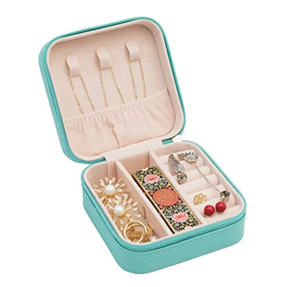 Open turquoise jewelry case with various accessories on a white background