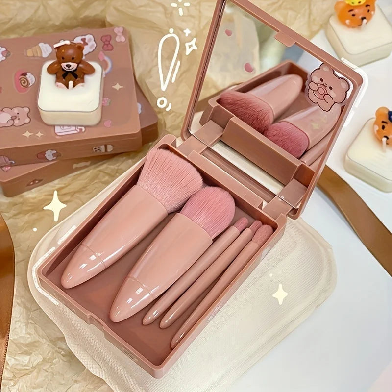 Makeup brush set with a mirror and pink handles in a decorative case.
