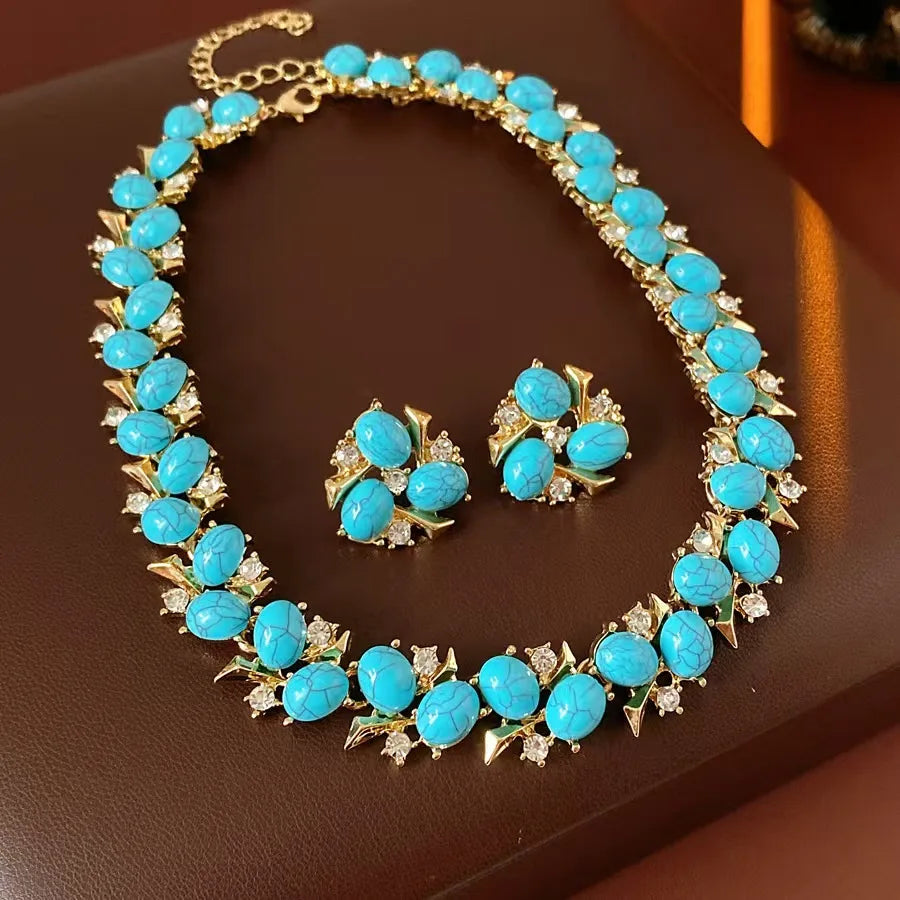 Turquoise jewelry set with necklace and earrings on a brown surface