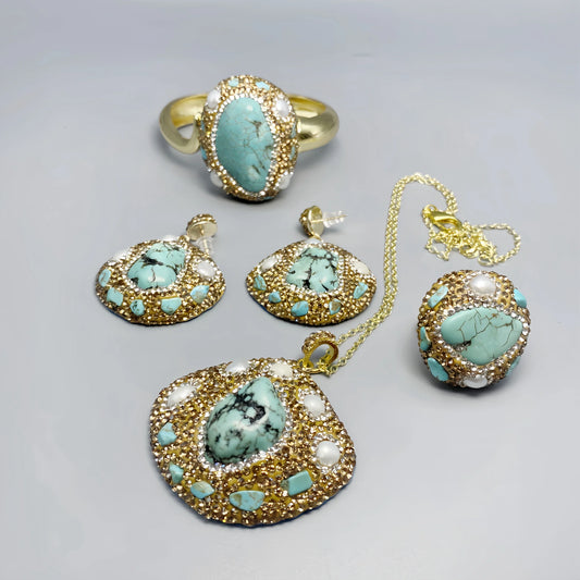 Jewelry set with turquoise stones and gold accents on a gray background